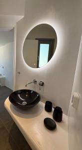 a bathroom with a black sink and a mirror at Maison Blanche in Vóthon +24 photos
