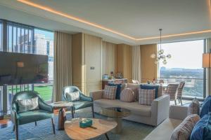 a living room with a couch and chairs at Park Hyatt Suzhou in Suzhou