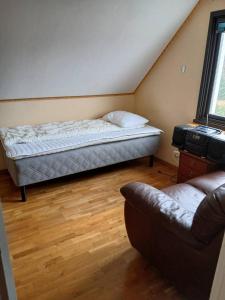 a bedroom with a bed and a couch in it at Workers Stay - Housing for Workers Volvo Torslanda in Gothenburg