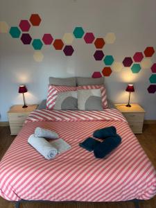 a bedroom with a large bed with towels on it at Maison villageoise in Anhée