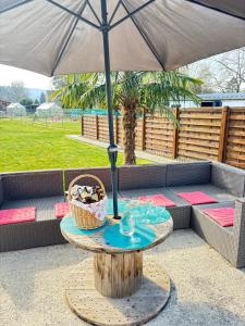 a table under an umbrella on a patio at Maison villageoise in Anhée +29 photos