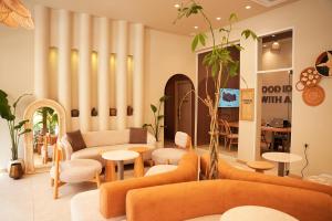 a living room with orange furniture and tables at SOHO Residence in Selçuk