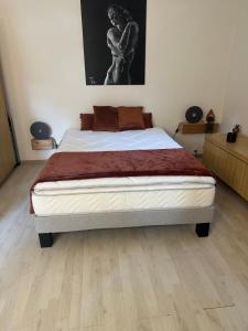 a bedroom with a large bed in a room at Euronat naturist studio in Grayan-et-lʼHôpital +9 photos