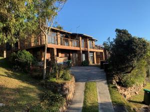 a large wooden house with a walkway in front of it at Crescent Clearwater - Revival in Crescent Head