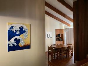 a dining room with a painting of a wave on the wall at Crescent Clearwater - Revival in Crescent Head +20 photos