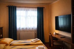 a hotel room with a bed and a window at Pension Javorník in Jeřmanice