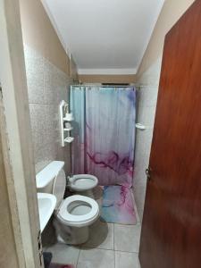 a bathroom with a shower with a toilet and a sink at Electra hospedaje familiar in Chicoana