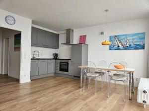 a kitchen and dining room with a table and chairs at Hafenblick in Kiel +16 photos