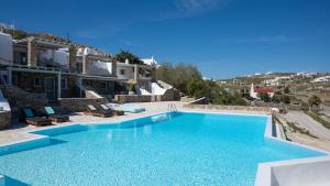 a villa with a swimming pool and a house at Myconian Vision Villas in Elia Beach