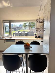 a kitchen with a table with a bowl of fruit on it at Maison villageoise in Anhée