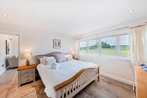 a bedroom with a large bed and a window at Greenwood House in Whitegate