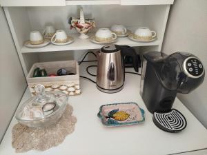 a kitchen counter with a coffee maker and dishes at "Cuore Barocco" Hospitality in Noto in Noto +19 photos