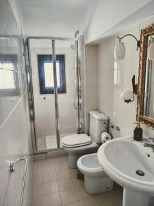 a bathroom with a toilet and a shower and a sink at "Cuore Barocco" Hospitality in Noto in Noto