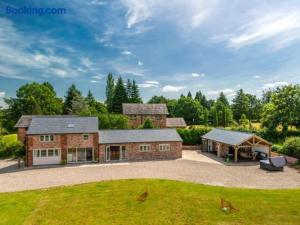 a large brick house with a gazebo at Greenwood House in Whitegate