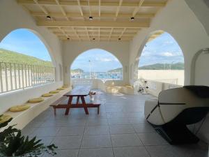 a room with a balcony with a table and a bench at Mộc House in Ninh Hải