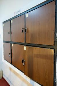 a row of wooden lockers in a room at Secret Surf Hostel in Weligama +38 photos