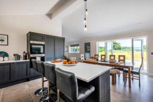a kitchen and dining room with a table and chairs at Greenwood House in Whitegate