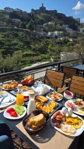 a table with many plates of food on it at Cumaku Boutique Hotel & Spa in Gjirokastër