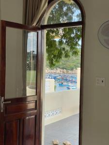 an open door with a view of the water at Mộc House in Ninh Hải