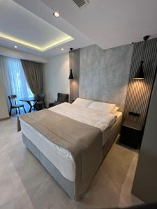 a bedroom with a large bed and a table and chairs at ARCADIA of BODRUM in Bodrum City +35 photos