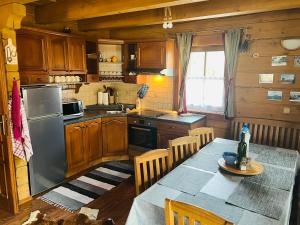a kitchen with wooden cabinets and a table with a table sidx sidx sidx at Zruby Liptovský Ján in Liptovský Ján
