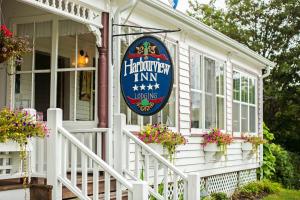 a white house with a harrington inn sign on it at Harbourview Inn in Smiths Cove