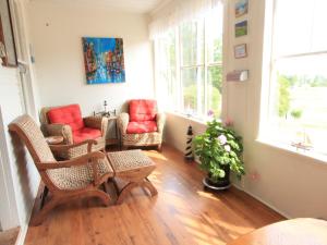 a living room with two chairs and a table at Harbourview Inn in Smiths Cove