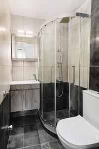 a bathroom with a shower and a toilet and a sink at FAOS Properties in Kavála +30 photos
