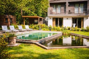a swimming pool in the yard of a house at Utopia Hotel - Art & Nature Hotel in Mons