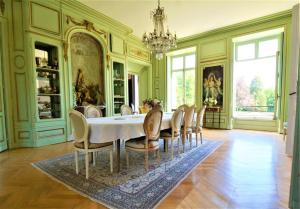 a dining room with a table and chairs at Chateau du boulay morin in Le Boulay-Morin