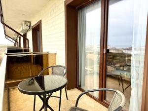 a table and chairs on a balcony with a view at Senin Vama Veche in Vama Veche