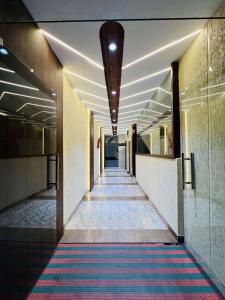 a hallway of a building with a colorful carpet at Hotel SHREE PALACE in Ratlām