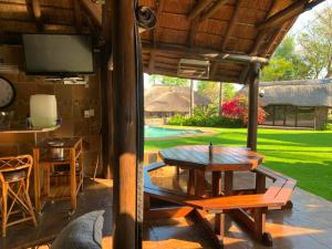 a patio with a table and a view of a yard at Lapa Phanzi Game Lodge in Modimolle