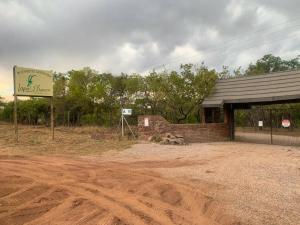 a building with a sign next to a dirt road at Lapa Phanzi Game Lodge in Modimolle +7 photos