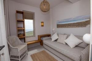 a living room with a couch and a window at Soborgo Exquisite Villas in Tinos +82 photos