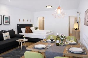 a living room with a table and a couch at Seelos - Alpine Easy Stay - Bed & Breakfast in Mieming +118 photos