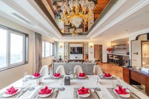a dining room with a table with chairs and a chandelier at Ninh Binh Legend Hotel in Ninh Binh