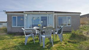 a table and chairs in front of a house at C35 Le Grace, Riviere Towans in Hayle +12 photos