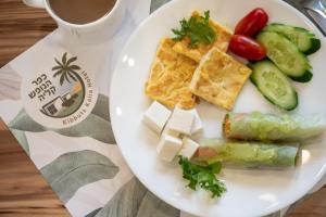 a white plate with food on a table at כפר נופש קלי"ה ים המלח in Kalia
