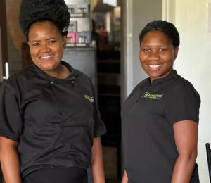 two women in black shirts posing for a picture at East Gate Rest Camp in Buitepos +44 photos