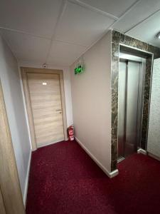 an empty hallway with a door and a red carpet at Liora Old City in Istanbul