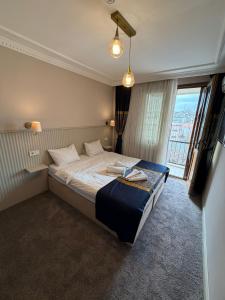 a bedroom with a bed and a large window at Liora Old City in Istanbul