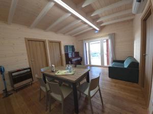 a dining room with a wooden table and chairs at Agriturismo Le Rondini Di San Bartolo in San Vincenzo