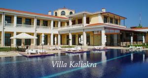 a large building with a swimming pool in front of it at Complex Villas Kaliakra & Gradina in Bŭlgarevo +79 photos