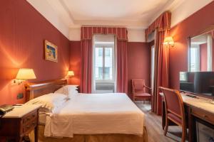 a hotel room with a bed and a desk at Best Western Hotel Rivoli in Rome