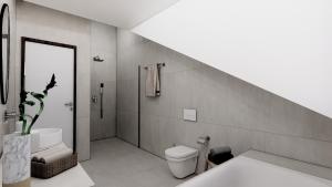 a bathroom with a toilet and a sink and a shower at Lakeside Studios Konstanz in Konstanz +5 photos