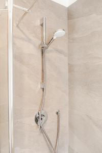 a shower with a shower head in a bathroom at The Nest Between Lake Como e Bellagio in Castelmarte +25 photos