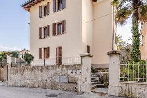 a white house with a fence and stairs at The Nest Between Lake Como e Bellagio in Castelmarte