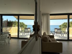 a living room with a view of the ocean at Seaside Escape in Trieste