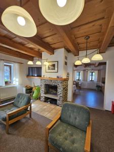 a living room with a couch and a fireplace at Penzion Pupík in Modrava